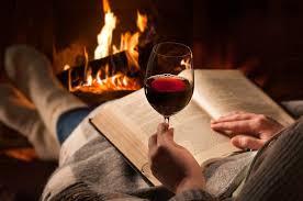 wine sense - reading by the fire with a glass of wine