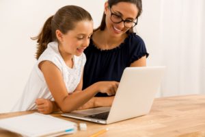 private school mother daughter on computer